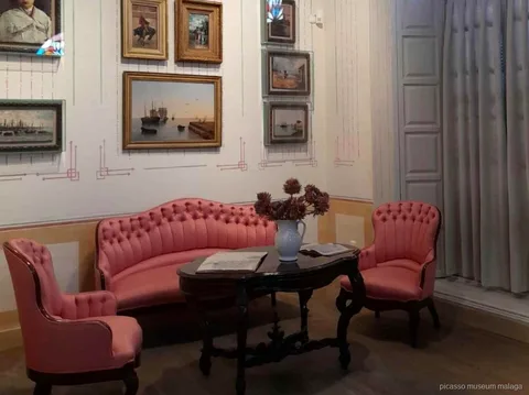 Visitor using the mobile audio guide app included with Picasso birthplace museum tickets