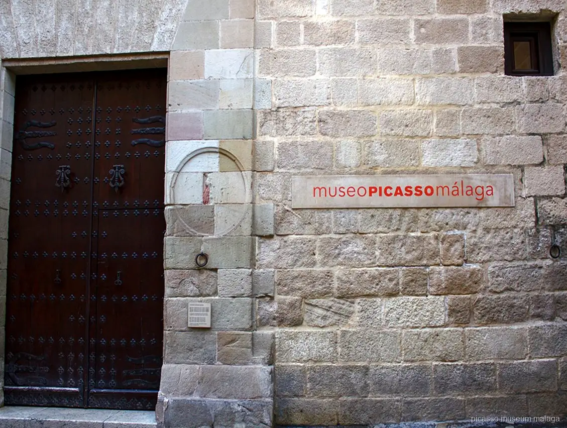 Guide leading a small group on a Picasso Museum Malaga guided tour outside the Palacio de Buenavista